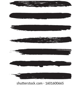 A set of grunge brushes. Dry brush strokes on a white background. Abstract black lines. Ink spots