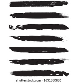 A set of grunge brushes. Dry brush strokes on a white background. Abstract black lines. Ink spots