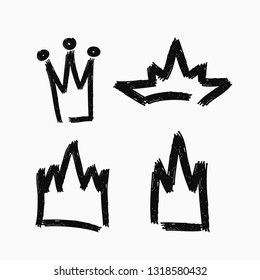 Set of grunge crowns drawn by hand. Collection of isolated icons painted with watercolor brush. Vector illustration.