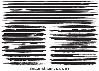 A set of grunge vector brushes. Strokes of black paint on white paper