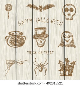 Set of Halloween icons drawn on white wooden background, holiday theme, illustration.