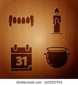 Set Halloween witch cauldron , Vampire teeth , Calendar with Halloween date 31 october and Burning candle  on wooden background. Vector