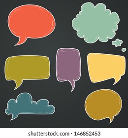 Set of hand drawn colorful speech and thought bubbles on chalkboard background.