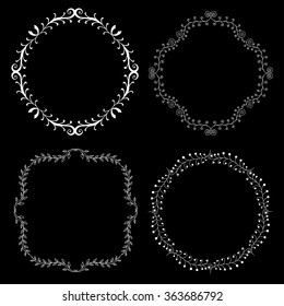 Set of hand drawn decorative frames. A set of four decorative frames. Set of decorative doodle wreaths made of branches. Black background. Black and white.