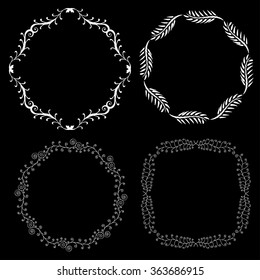 Set of hand drawn decorative frames. A set of four decorative frames. Set of decorative doodle wreaths made of branches. Black background. Black and white.
