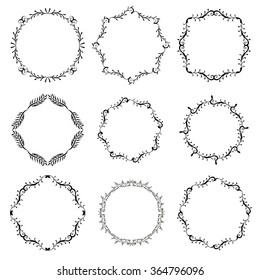 Set of hand drawn decorative frames. A set of four decorative frames. Set of decorative doodle wreaths made of branches. White background. Black and white.
