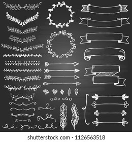 Set of hand drawn design elements. Arrows, wreath, floral elements, swrils on the blackboard