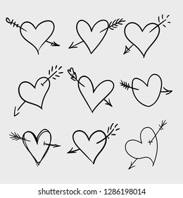 Set of hand drawn doodle hearts with arrows. Valentine's day design elements. Hand written greetings.