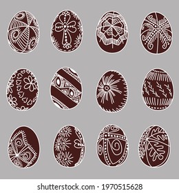 Set of hand drawn Easter eggs with white lines on a brown background. Ethnic traditional motive Ukrainian national pattern. Pattern with sun, waves, flowers, cross, wedges, oak, rose, star