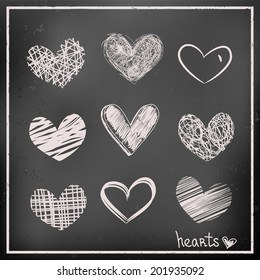 Set of hand drawn hearts on chalkboard background. Sketch vector icons for design