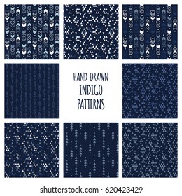 Set of hand drawn indigo blue and white patterns. Seamless vector triblal aztec backgrounds with triangles and arrows.