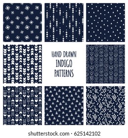 Set of hand drawn indigo blue and white patterns. Seamless vector triblal aztec backgrounds with triangles and arrows.
