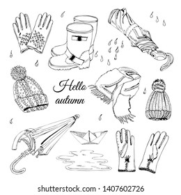 Set with hand drawn of items of autumn clothes, drops, puddle and paper boat. Monochrome  ink sketch elements  isolated on white background.