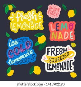 Set hand drawn lettering inscriptions on dark background with flat style lemon fruits and leaves. Stickers with Sugar Free, Fresh, Ice Cold and Squeezed Lemonade. Perfect for cover, menu, cafe, poster