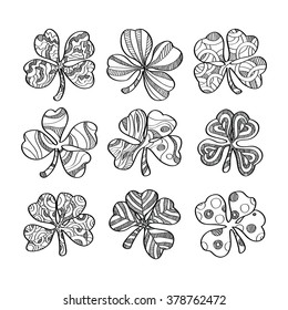 Set of hand drawn monochrome shamrock isolated on white background. Vector illustration.