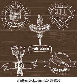 Set of hand drawn retro grill and barbecue emblems on the vector wooden background