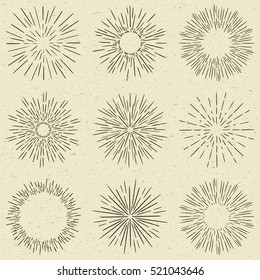 Set of hand drawn retro sunburst, fireworks or bursting rays design elements. Vintage style, grunge paper background.