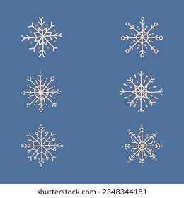 Juego de copos de nieve dibujados a mano sobre fondo azul