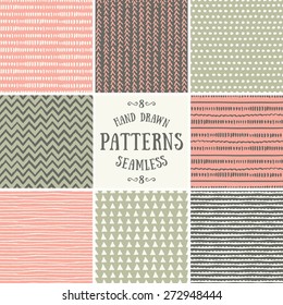 A set of hand drawn style abstract seamless patterns. Tiling repeat backgrounds collection in pastel pink, green and brown.