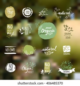 Set of hand drawn style badges and elements for organic food and drink, natural products, restaurant, healthy food market and production, on the nature background. Vector illustrations.