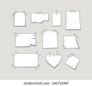 Set of hand drawn white note paper fixed on wall with sticky tape. 