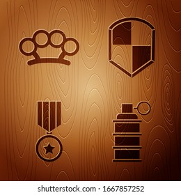 Set Hand grenade, Brass knuckles, Military reward medal and Shield on wooden background. Vector