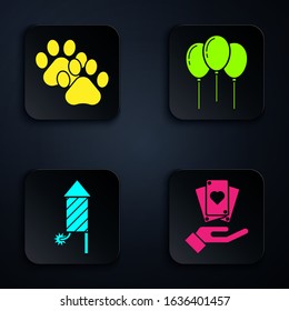 Set Hand holding playing cards, Paw print, Firework rocket and Balloons with ribbon. Black square button. Vector