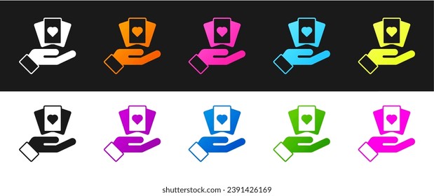 Set Hand holding playing cards icon isolated on black and white background. Casino game design.  Vector