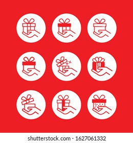 Set of hand icons holding a red gift box - vector illustration