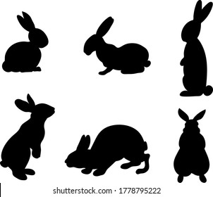 Set of hand-drawn running, looking up and sitting in various poses rabbits black silhouette . Set of Easter bunny outlines isolated on white background. Simple cartoon bunny.