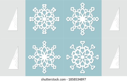 Set of handmade snowflakes made of paper on a blue background 