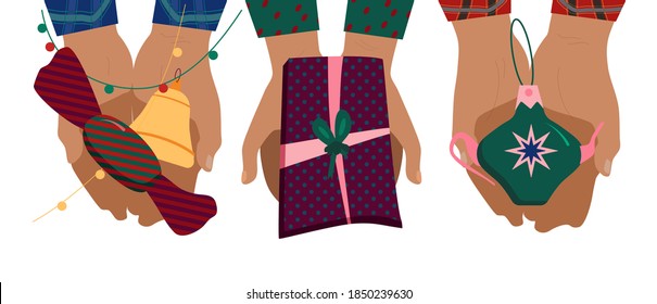 Set of hands holding gift box with festive paper, Christmas tree toy in teapot form and huge candy. Checkered shirt sleeves for cozy family celebration.new year decoration with garland.Birthday party