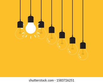 Set of hanging light bulbs with one glowing. Leadership, power and uniqueness concept.