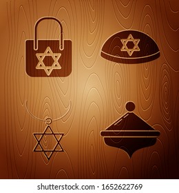 Set Hanukkah dreidel, Shopping bag with star of david, Star of David necklace on chain and Jewish kippah with star of david on wooden background. Vector
