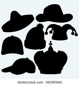 Set of headgear. Crown, winter hat, baseball cap, cowboy hat, jester hat and mexican. Isolated on blue background. Vector silhouettes