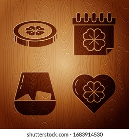 Set Heart with four leaf clover, Gold coin with four leaf clover, Glass of whiskey and Saint Patricks day with calendar on wooden background. Vector