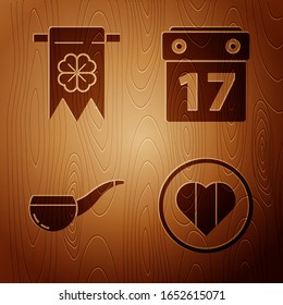 Set Heart and Happy Saint Patrick day, Four leaf clover and party pennant, Smoking pipe and Saint Patrick's day with calendar on wooden background. Vector