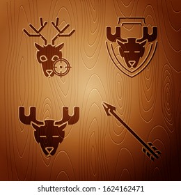 Set Hipster arrow, Hunt on deer with crosshairs, Moose head with horns and Moose head on shield on wooden background. Vector