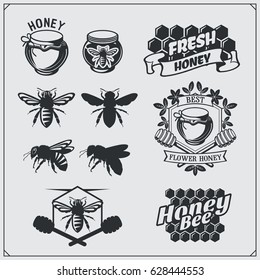 Set of honey labels, badges and design elements. Honeycombs, bee silhouettes, honey emblems.