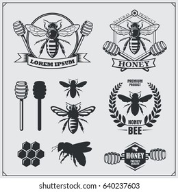 Set of honey labels, badges and design elements. Honeycombs, bee silhouettes, honey emblems.