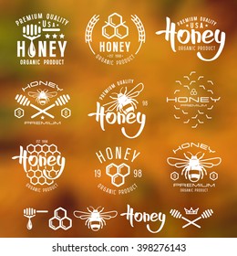 Set of honey labels, badges, logotypes and design elements. White print on blurred background