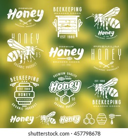 Set of honey labels, badges, logotypes and design elements. White print on blurred background