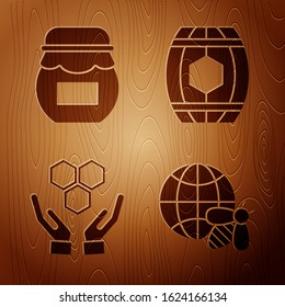 Set Honeycomb map of the world and bee, Jar of honey, Honeycomb and hands and Wooden barrel with honey on wooden background. Vector