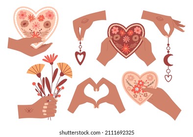 A set of human hands holding boho elements, a bouquet giving a flower heart, a gesture depicting a heart. Cute boho style illustrations. Vector illustrations isolated on a white background