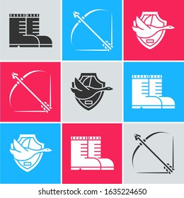 Set Hunter boots, Bow and arrow in quiver and Flying duck on shield icon. Vector