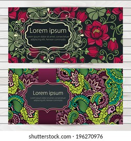 Set of invitation or wedding cards with floral background and elegant floral elements. Placed on wooden background. eps10