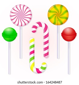 set of isolated candies lollipops on background of cream color
