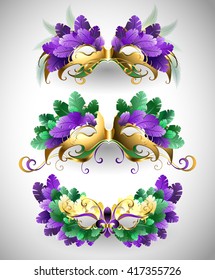 Set of isolated colorful ardi Gras masks decorated with purple, green, yellow feathers.