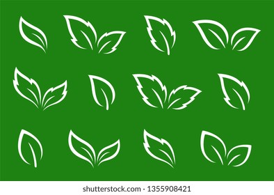 set of isolated hand drawn abstract white leaves icons on green background