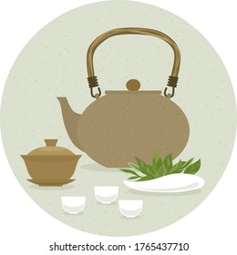 A set of items for traditional Chinese tea drinking Pin Cha. The kettle, gaiwan and the green tea leaves.